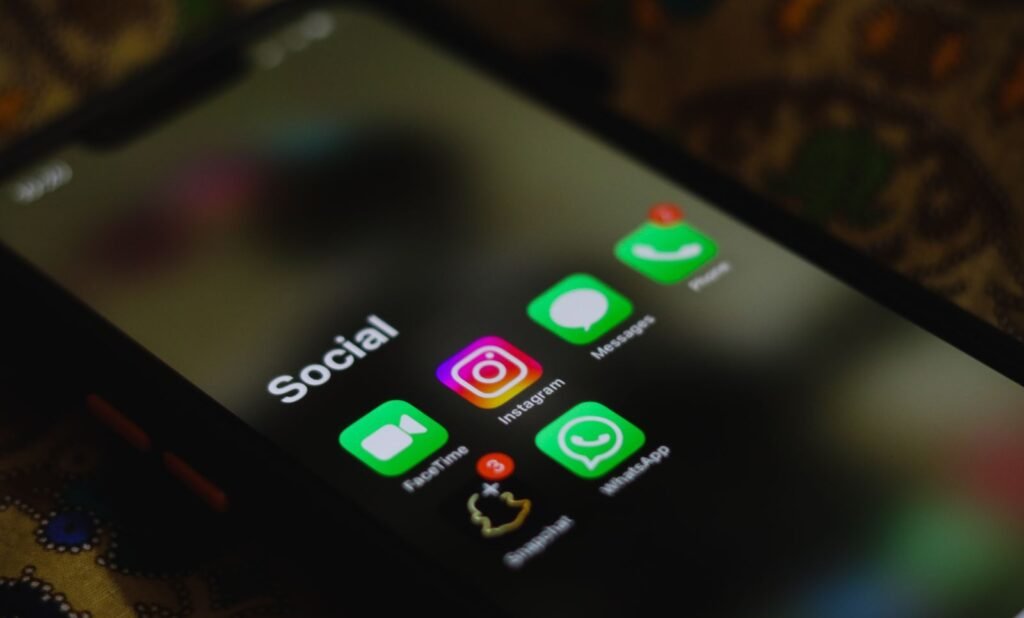 Smartphone displaying messaging app icons on screen