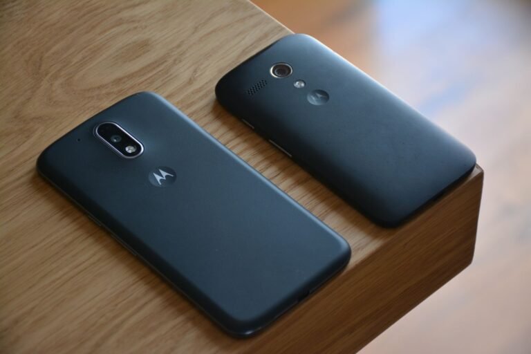 Two smartphones placed on a wooden table