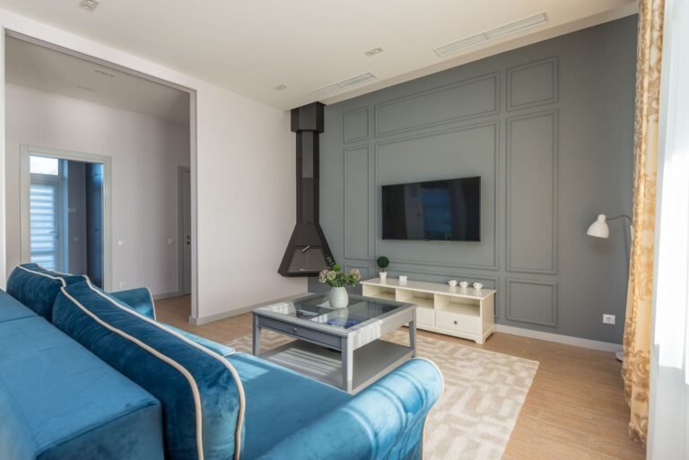 A living room featuring a couch and wall-mounted TV