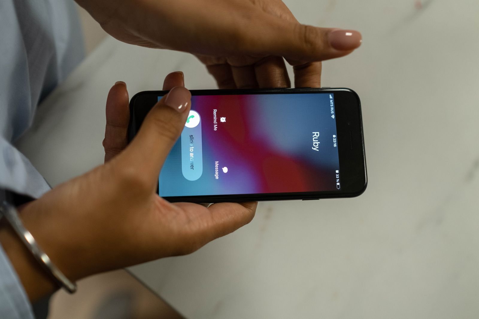 Hands holding a smartphone receiving an incoming call
