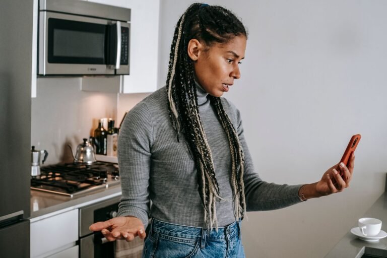 Person looking frustrated while using a smartphone